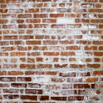 Concrete splatter on brick wall
