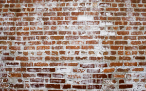 Concrete splatter on brick wall
